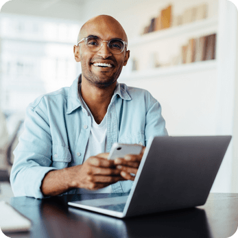 Smiling entrepreneur filing a VAT return using the Online Filings platform
