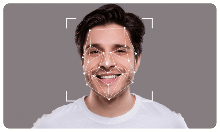 A Young Man Is Smiling While Being Analyzed by Facial Recognition Technology